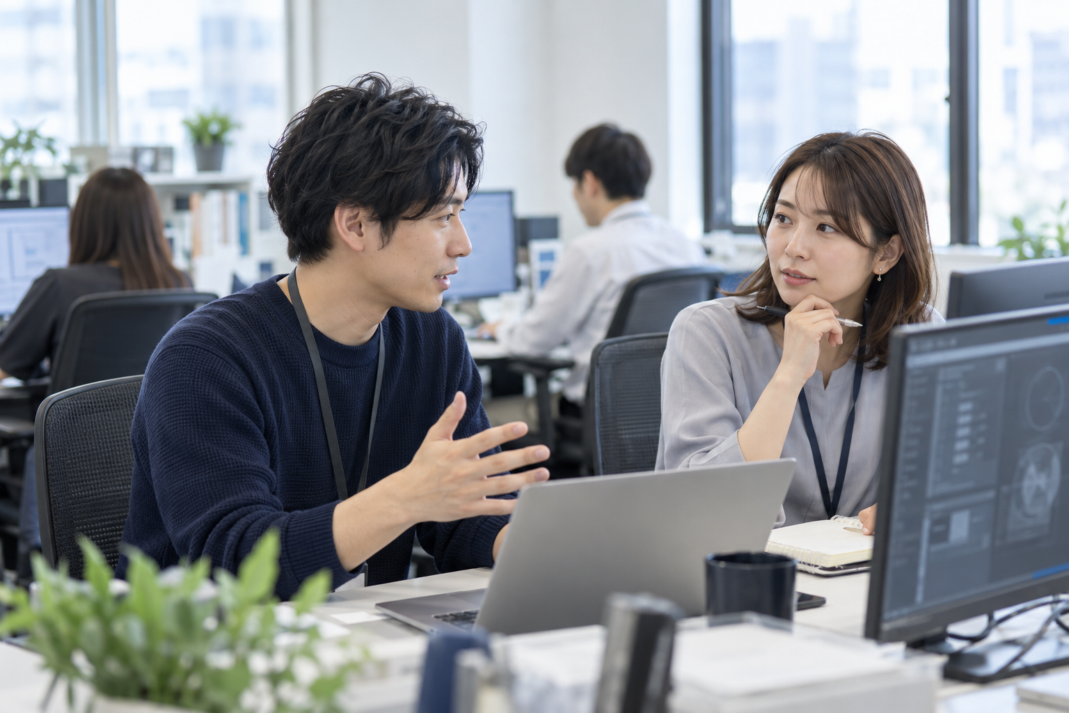 仕事風景のイメージ（AI生成・架空の人物と職場）